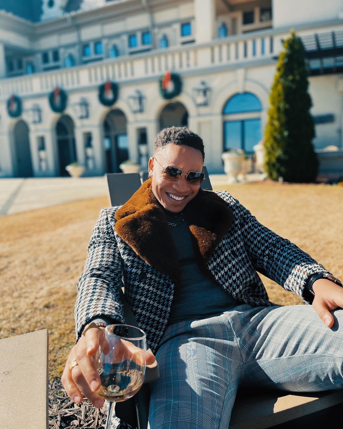 Vanessa Mdee's baby daddy Rotimi poses outside the mansion he bought her